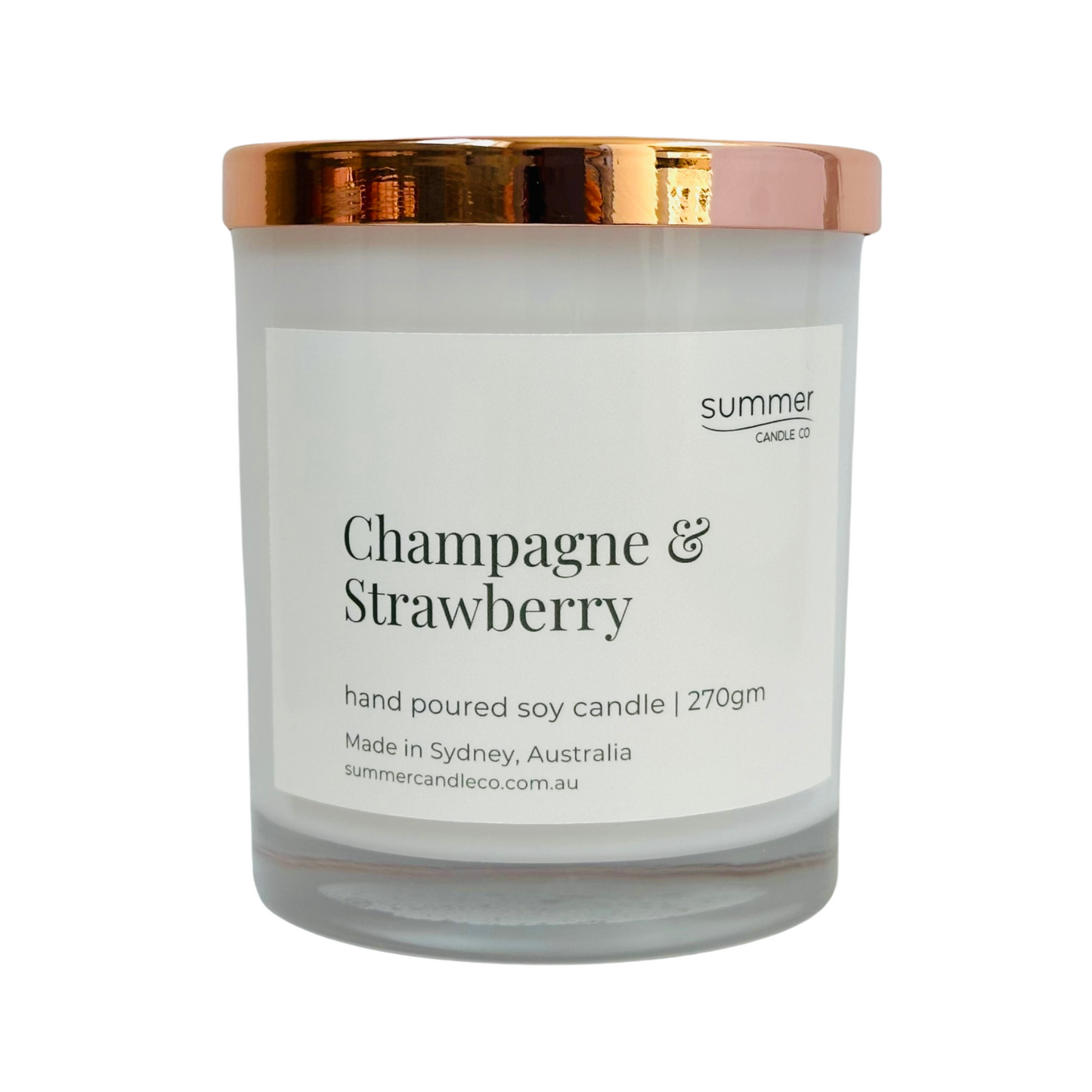 Hand-poured soy wax candle in a white jar with a rose gold lid, scented with Champagne & Strawberry. A sparkling, fruity blend with notes of ripe strawberries and bubbly champagne. Clean-burning and perfect for gifting or adding a festive touch.