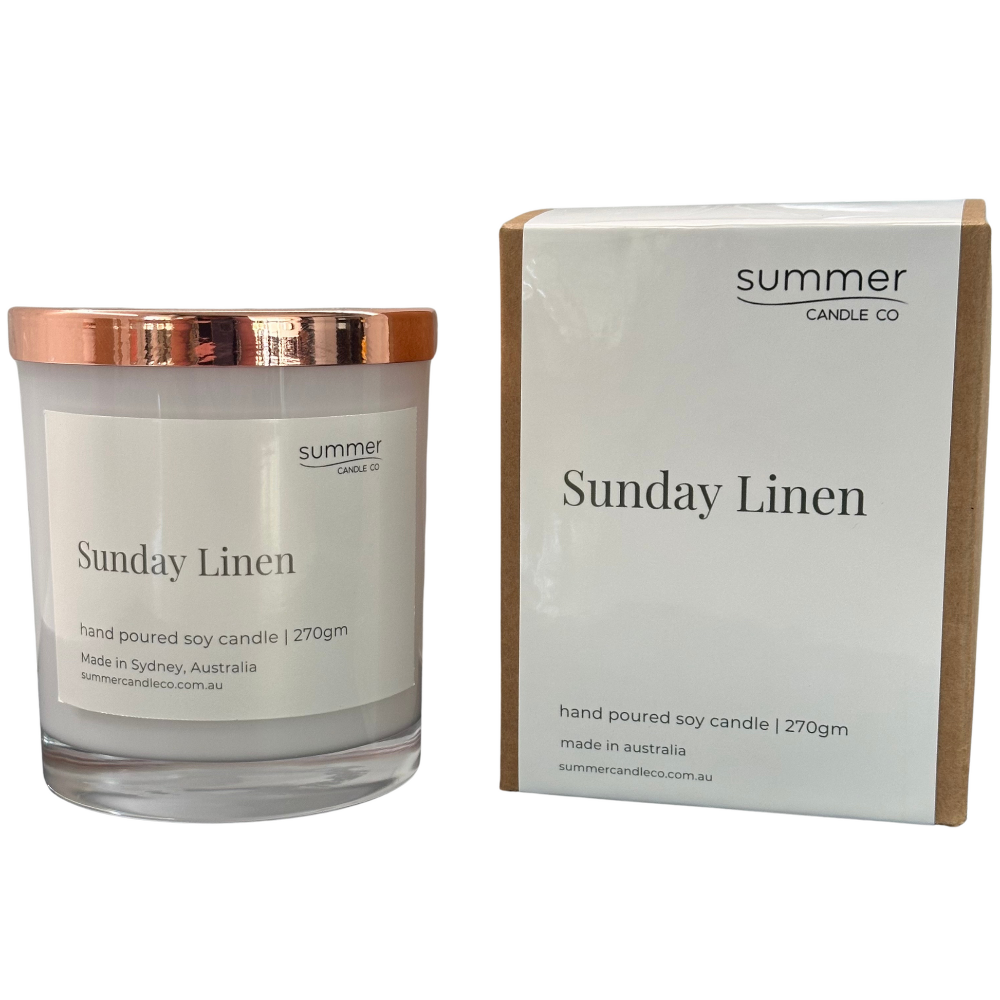 Clear glass soy wax candle jar labeled “Sunday Linen” with a sleek rose gold lid, featuring minimalist and elegant packaging. The candle evokes fresh, clean linen scents, perfect for creating a calm and cozy atmosphere at home. Ideal as a stylish gift or for enhancing your living space with subtle, soothing fragrance and modern home decor appeal.