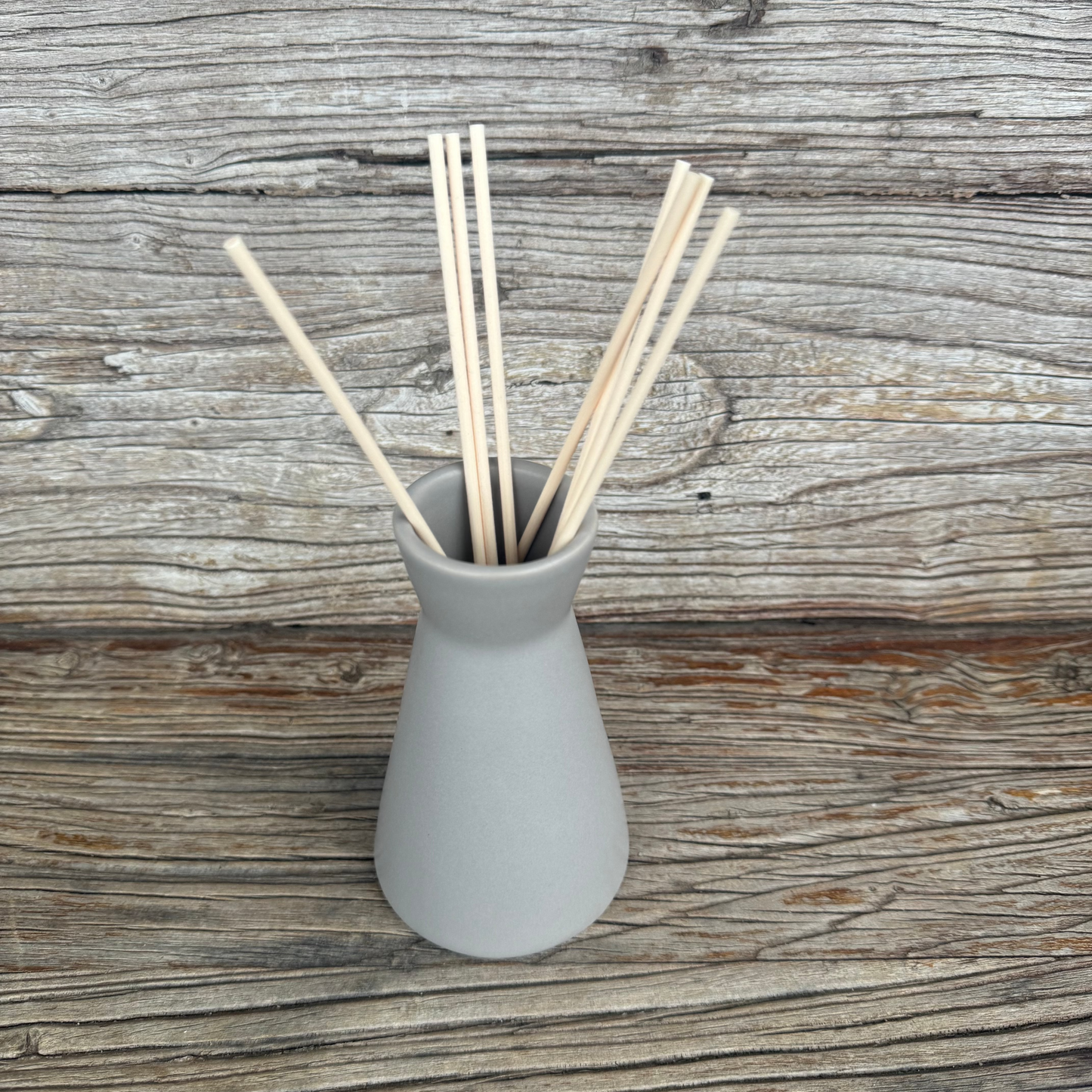 Taupe coloured ceramic reed diffuser with natural reeds
