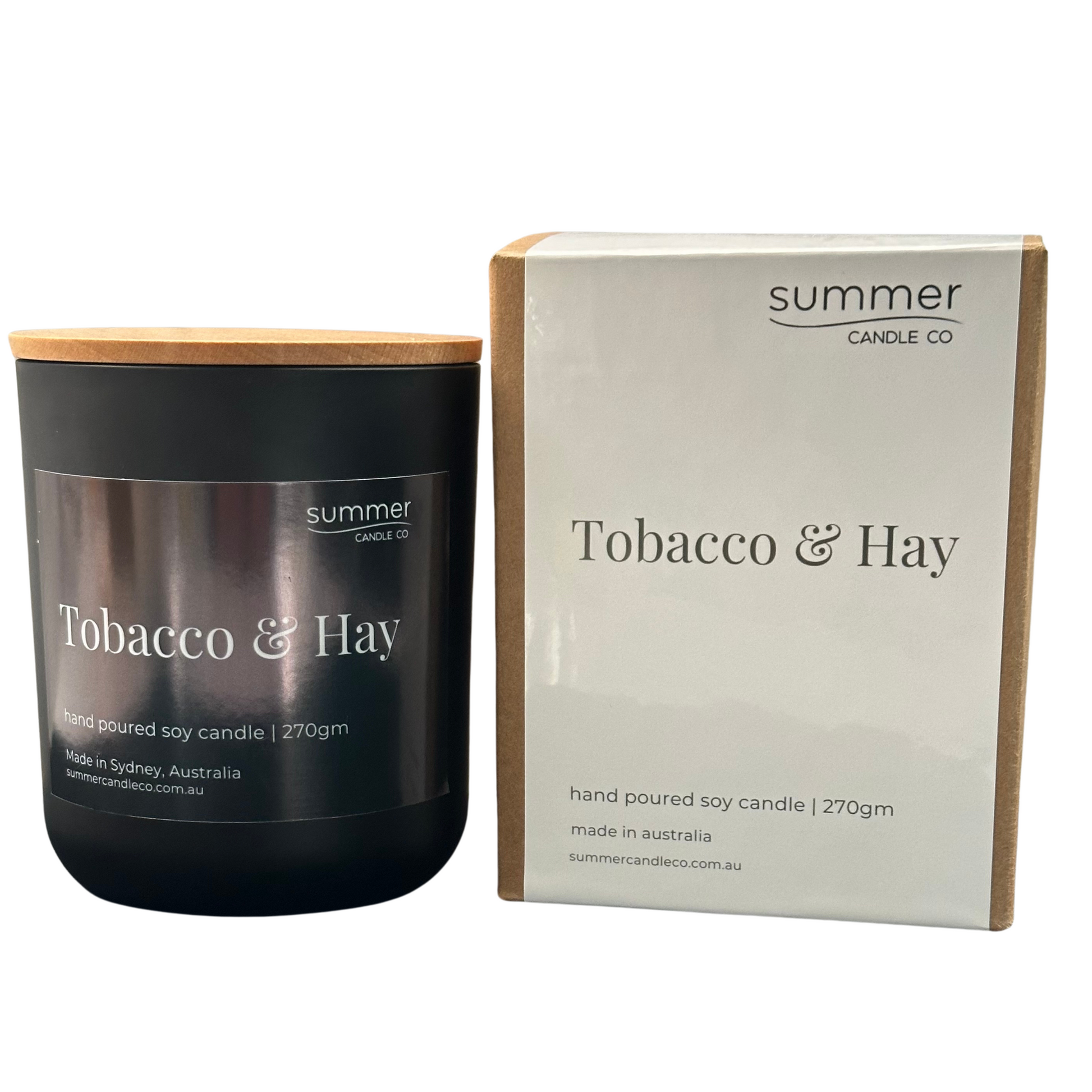 Hand-poured soy wax candle in a sleek black jar with a natural wooden lid, scented with Tobacco & Hay. Features earthy notes of dried hay, tobacco leaf, and musk. A clean-burning, masculine fragrance ideal for creating a warm, rustic atmosphere.