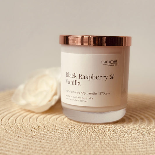 Hand-poured soy wax candle in a white jar with a rose gold lid, scented with Black Raspberry & Vanilla. A sweet, fruity blend of ripe berries and creamy vanilla. Clean-burning and perfect for gifting or adding a touch of indulgence to your space.