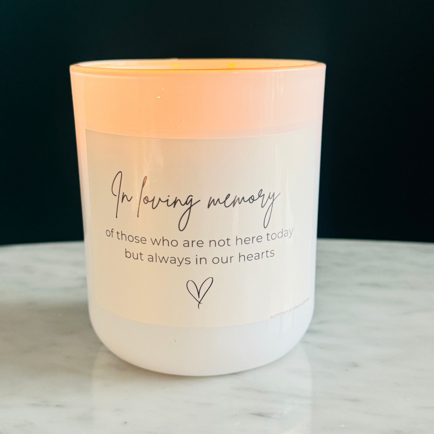 White candle with text 'In Loving Memory of those who are not here today but always in our hearts'