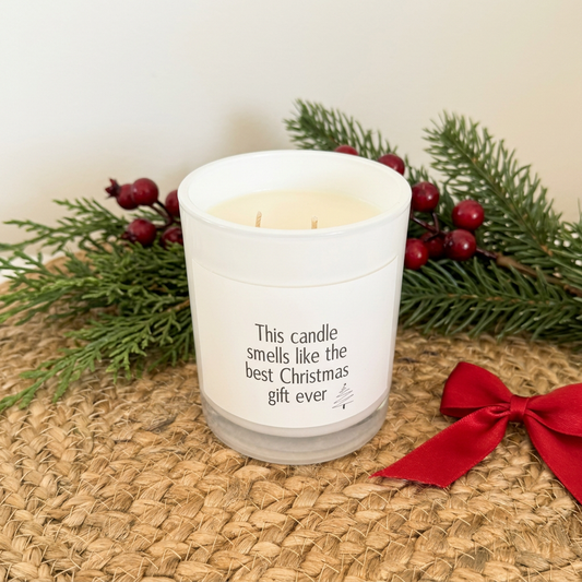 Best Gift Ever candle on rattan with subtle Christmas greenery, berries and red ribbon