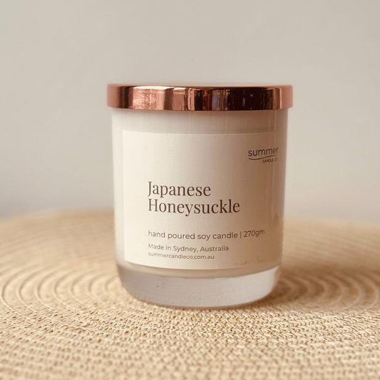 Japanese Honeysuckle candle on a natural rattan mat
