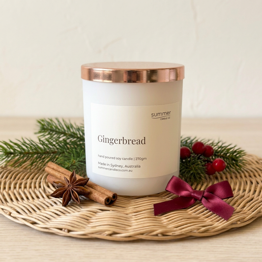 Gingerbread candle with evergreen, cinnamon sticks, star anise, red berries and ribbon
